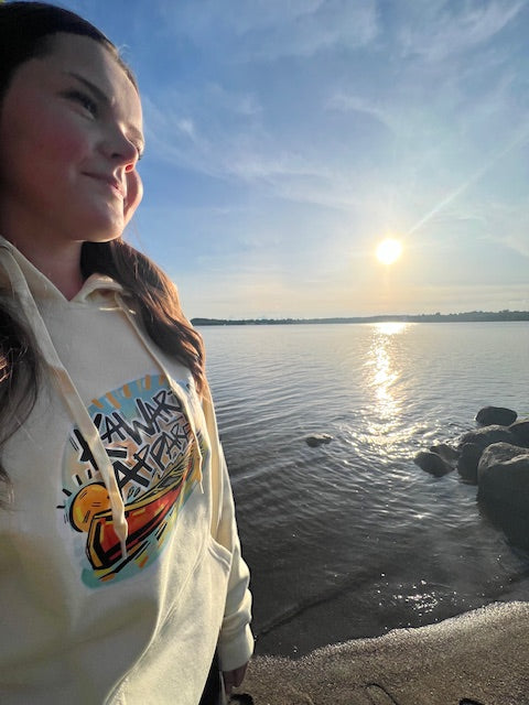 woman on the beach at sunset wearing Founders Edition Hoodie