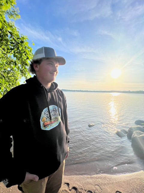 Man on the beach at sunset wearing Founders Edtion Hoodie