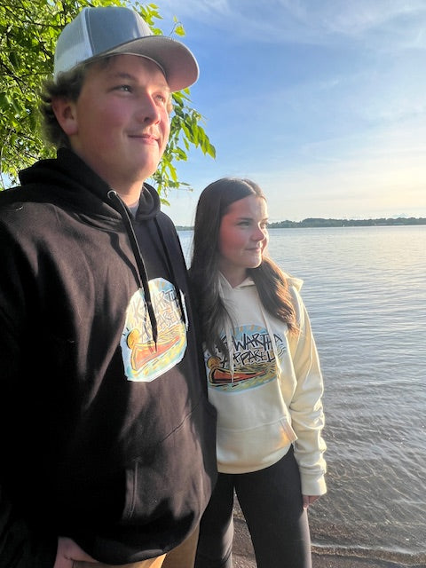 Man and woman on the beach wearing Founders Edition hoodies