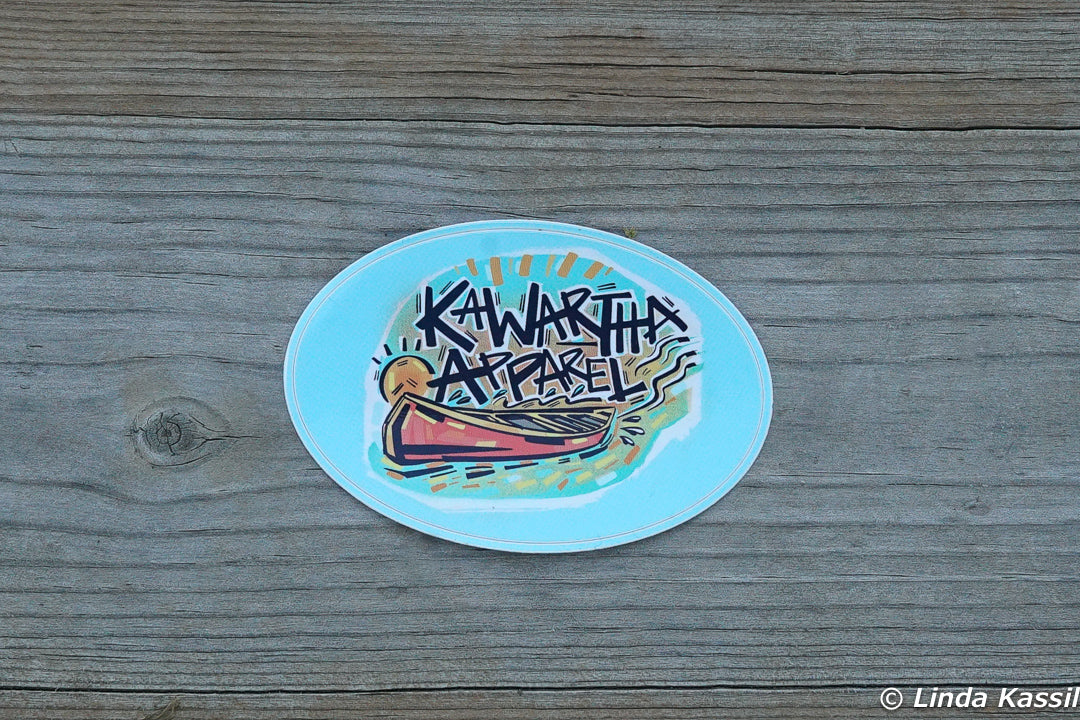 Kawartha Apparel 2" x 3" oval sticker on a dock